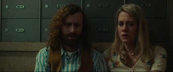 Movie still from “Stockholm” (2018), directed by Robert Budreau – A man and a woman sitting next to each other on a train; Close Up shot, Low angle