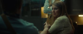 Movie still from “Stockholm” (2018), directed by Robert Budreau – A woman smoking a cigarette while sitting in a room; Close Up shot, Over the shoulder angle