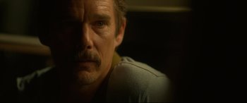 Movie still from “Stockholm” (2018), directed by Robert Budreau – A man with a mustache; Close Up shot, Over the shoulder angle