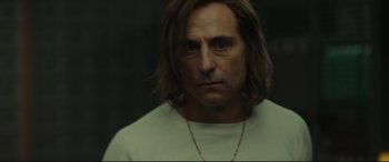 Movie still from “Stockholm” (2018), directed by Robert Budreau – A person with long hair; Close Up shot, Low angle