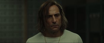 Movie still from “Stockholm” (2018), directed by Robert Budreau – A person with long hair; Close Up shot, Over the shoulder angle
