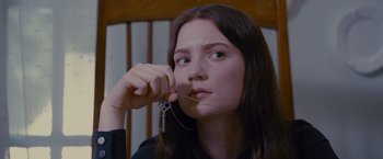 Movie still from “Stoker” (2013), directed by Park Chan-wook – A woman holding a key in her hand; Close Up shot, High angle