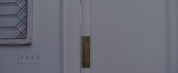 Movie still from “Stoker” (2013), directed by Park Chan-wook – A door that has a brass plaque on it; Extreme Close Up shot, Overhead angle