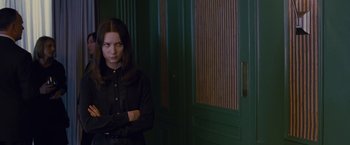 Movie still from “Stoker” (2013), directed by Park Chan-wook – A woman standing in front of a green door; Medium shot, Low angle