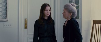 Movie still from “Stoker” (2013), directed by Park Chan-wook – A woman in a black shirt and a woman in a black dress; Medium shot, Over the shoulder angle