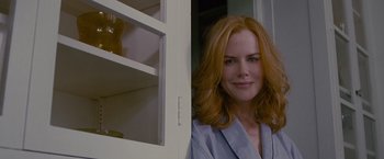 Movie still from “Stoker” (2013), directed by Park Chan-wook – A woman standing in front of a window with a cat; Close Up shot, Over the shoulder angle