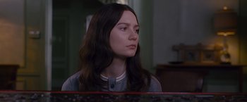 Movie still from “Stoker” (2013), directed by Park Chan-wook – A woman sitting in front of a piano looking to her left; Close Up shot, Low angle