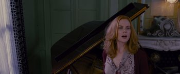 Movie still from “Stoker” (2013), directed by Park Chan-wook – A woman standing in front of a grand piano; Close Up shot, Over the shoulder angle