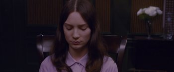Movie still from “Stoker” (2013), directed by Park Chan-wook – A woman sitting in a chair with her eyes closed; Close Up shot, High angle