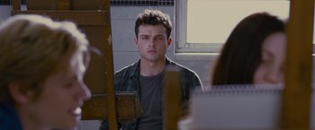 Movie still from “Stoker” (2013), directed by Park Chan-wook – A man sitting in front of an easel in front of a window; Medium shot, Over the shoulder angle