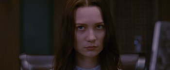 Movie still from “Stoker” (2013), directed by Park Chan-wook – A person with long brown hair; Close Up shot, Over the shoulder angle