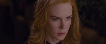 Movie still from “Stoker” (2013), directed by Park Chan-wook – A person with long hair and blue eyes; Close Up shot, Over the shoulder angle