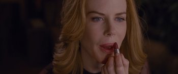 A person putting lipstick on