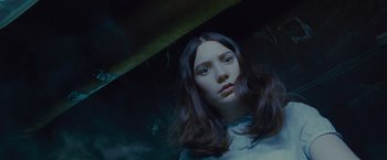 Movie still from “Stoker” (2013), directed by Park Chan-wook – A woman with long brown hair is looking at the camera; Close Up shot, Overhead angle