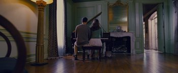 Movie still from “Stoker” (2013), directed by Park Chan-wook – A man and a woman sitting at a grand piano; Wide shot, High angle