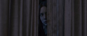 Movie still from “Stoker” (2013), directed by Park Chan-wook – A woman is looking through a curtain at the camera; Close Up shot, Low angle