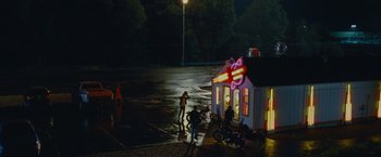 Movie still from “Stoker” (2013), directed by Park Chan-wook – A group of people standing in a parking lot at night; Extreme Wide shot, High angle