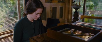 Movie still from “Stoker” (2013), directed by Park Chan-wook – A young woman sitting at a piano looking down; Medium shot, High angle
