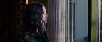 Movie still from “Stoker” (2013), directed by Park Chan-wook – A woman looking out of a window at night; Close Up shot, Over the shoulder angle