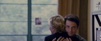 Movie still from “Stoker” (2013), directed by Park Chan-wook – Two people hugging each other in front of a window; Medium shot, Over the shoulder angle