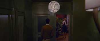 Movie still from “Stoker” (2013), directed by Park Chan-wook – A man and a woman standing in front of a door; Wide shot, Low angle