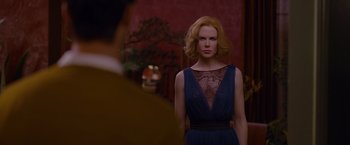 Movie still from “Stoker” (2013), directed by Park Chan-wook – A woman standing in front of a mirror in a blue dress; Medium shot, Over the shoulder angle