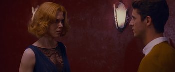 Movie still from “Stoker” (2013), directed by Park Chan-wook – A woman standing in front of a mirror in front of a red wall; Close Up shot, Over the shoulder angle