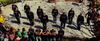 A group of men standing next to each other on top of a building