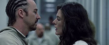 Movie still from “Stone” (2010), directed by John Curran – A man and a woman face to face in front of other people; Close Up shot, Low angle