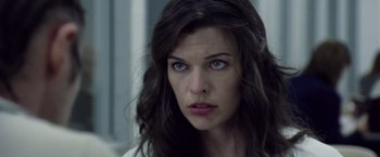 Movie still from “Stone” (2010), directed by John Curran – A person with long dark hair; Close Up shot, Over the shoulder angle
