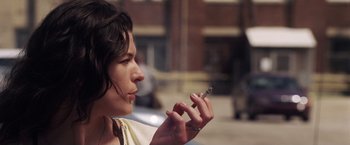 Movie still from “Stone” (2010), directed by John Curran – A woman is holding a cigarette in her hand; Close Up shot, Over the shoulder angle