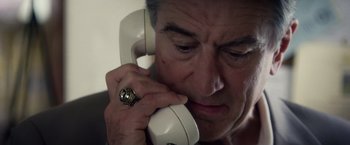 Movie still from “Stone” (2010), directed by John Curran – A person talking on a phone; Close Up shot, Overhead angle
