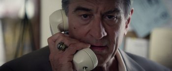 Movie still from “Stone” (2010), directed by John Curran – A person talking on a phone; Close Up shot, Low angle