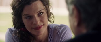 Movie still from “Stone” (2010), directed by John Curran – A woman's face with green eyes; Close Up shot, Over the shoulder angle