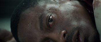 Movie still from “Stone” (2010), directed by John Curran – A man's eye with a tear coming out of it; Extreme Close Up shot, Overhead angle