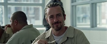 Movie still from “Stone” (2010), directed by John Curran – A person holding a tooth brush in his mouth; Close Up shot, Low angle