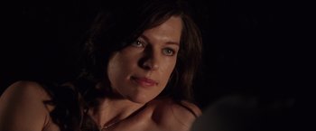 Movie still from “Stone” (2010), directed by John Curran – A woman's face in the dark; Close Up shot, Over the shoulder angle