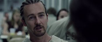 Movie still from “Stone” (2010), directed by John Curran – A person sitting in a room; Close Up shot, Over the shoulder angle