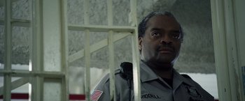 Movie still from “Stone” (2010), directed by John Curran – A man that is in a jail cell; Close Up shot, Low angle