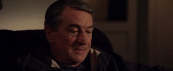 Movie still from “Stone” (2010), directed by John Curran – An older man sitting in front of a window; Close Up shot, Over the shoulder angle