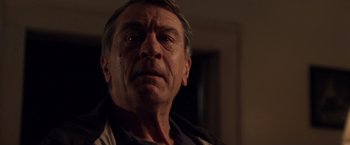 Movie still from “Stone” (2010), directed by John Curran – An older man looking into the distance with a sad look; Close Up shot, Low angle