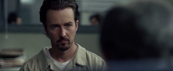 Movie still from “Stone” (2010), directed by John Curran – A person with a beard; Close Up shot, Over the shoulder angle