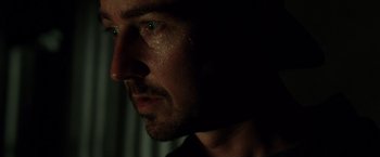 Movie still from “Stone” (2010), directed by John Curran – A man's face with water droplets on his face; Close Up shot, Low angle