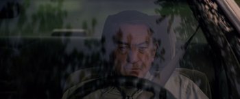 Movie still from “Stone” (2010), directed by John Curran – A person driving a car; Close Up shot, Over the shoulder angle