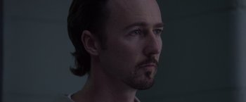 Movie still from “Stone” (2010), directed by John Curran – A person with a beard looking to his left; Close Up shot, Over the shoulder angle