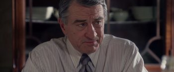 Movie still from “Stone” (2010), directed by John Curran – An older man wearing a striped dress shirt and tie; Close Up shot, Over the shoulder angle