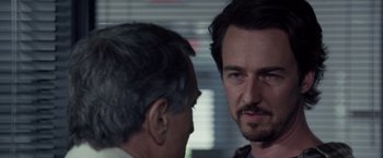 Movie still from “Stone” (2010), directed by John Curran – A man and a man standing next to each other; Close Up shot, Over the shoulder angle