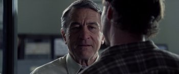 Movie still from “Stone” (2010), directed by John Curran – An older man talking to a younger man in front of a mirror; Close Up shot, Over the shoulder angle