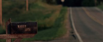 Movie still from “Stone” (2010), directed by John Curran – A mailbox on the side of the road; Extreme Close Up shot, Low angle