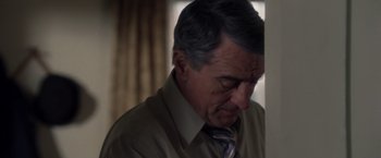 Movie still from “Stone” (2010), directed by John Curran – An older man wearing a shirt and a tie; Close Up shot, High angle